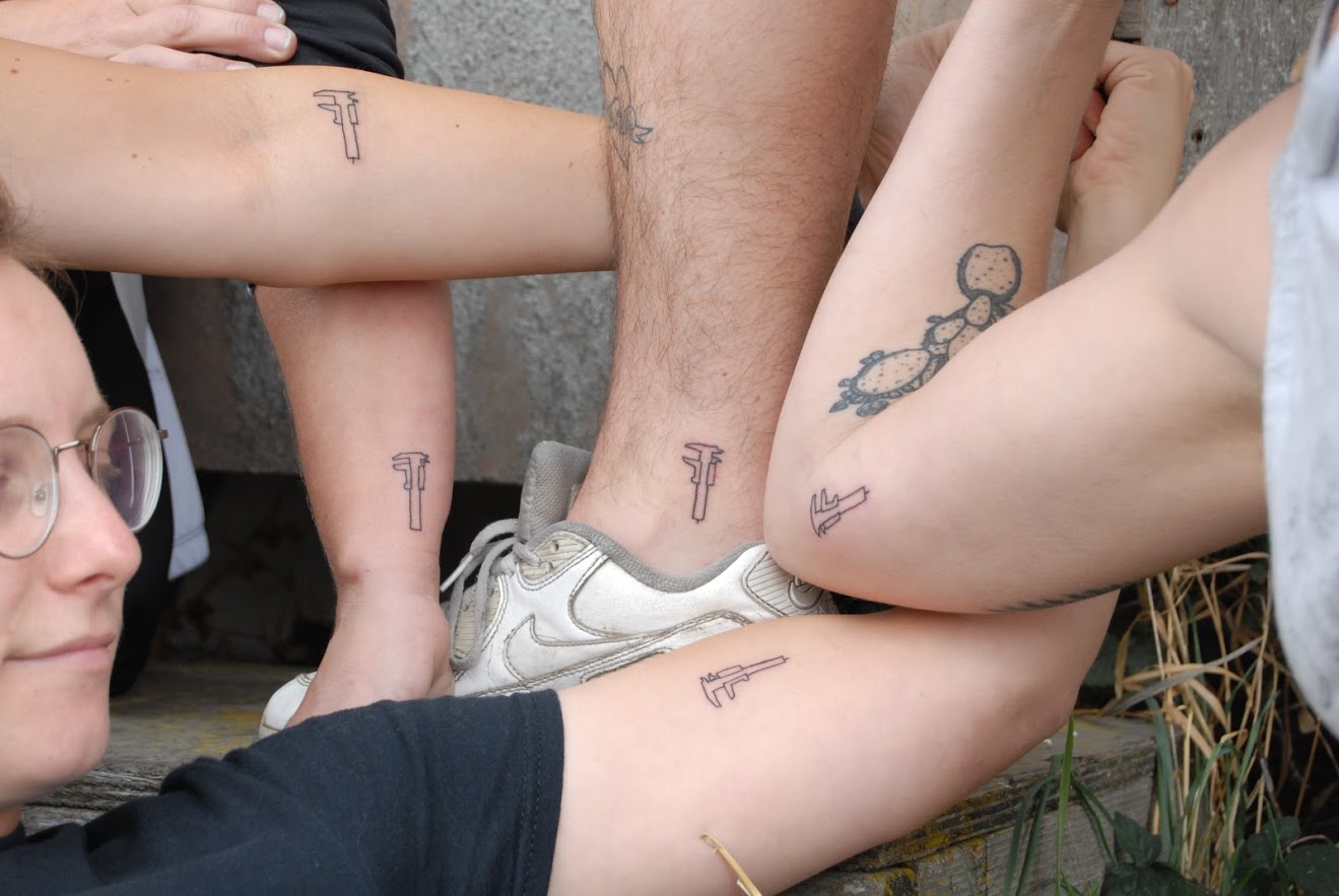 Holt and classmates tattooed a 1" or 25.4mm vernier caliper as a reminder of their time at the QBP Bike Mechanic Scholarship. Measuring is important!
