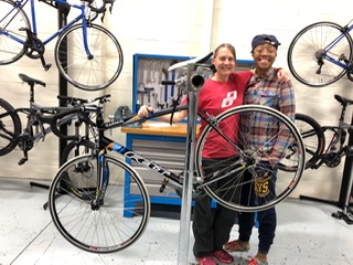 Jiosne and bench partner Nelly Jones proudly display their overhauled bike at the end of Day 7. 