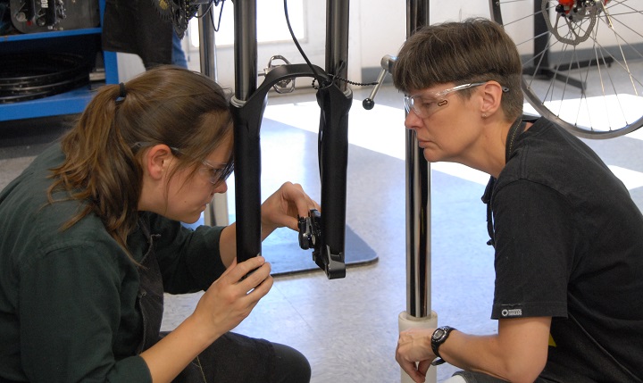 Wood and bench partner Val Scheiffler work through a disc brake bleed. 