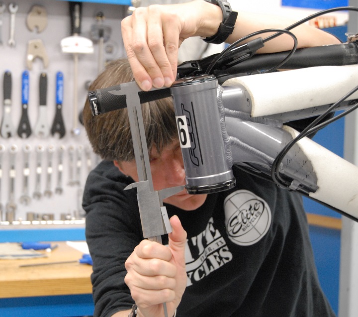 Wood measuring the headtube during a headset replacement exercise.